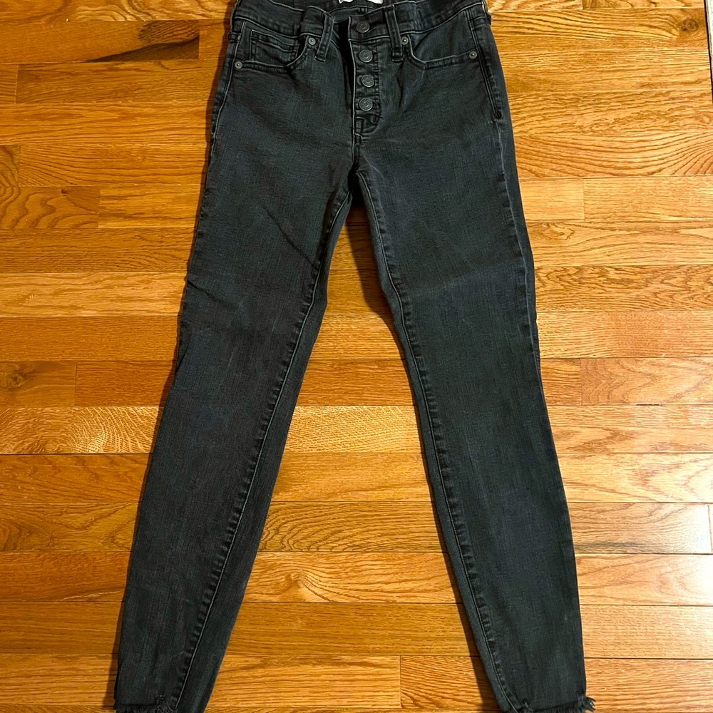 Madewell button front black wash skinny jean with frayed ankle detail.